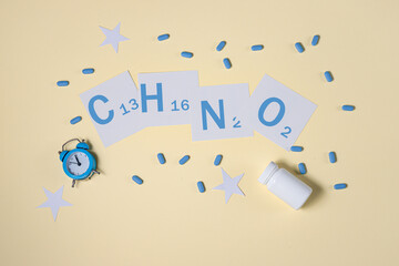 the concept of self-care, good sleep, sleeplessness in yellow tones. pills for insomnia. inscription melatonin formula