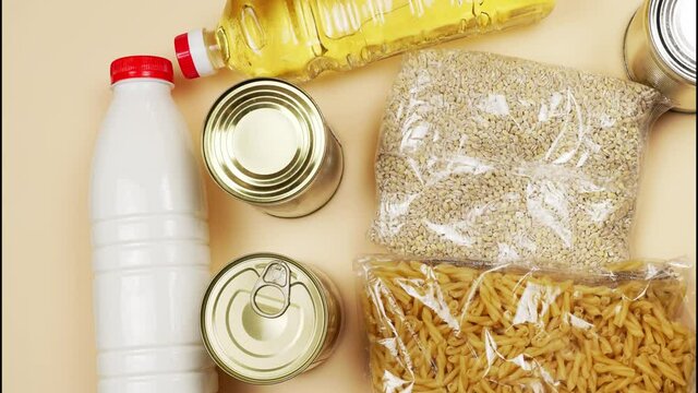 Donations or a set of products for the crisis, a paper bag with food intended for sending humanitarian aid to the victims of the blockade. Stop motion movement of products.