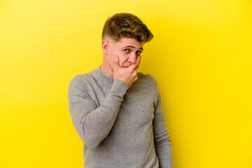 Young caucasian man isolated on yellow background scared and afraid.