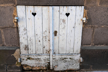 A window with shutters on the street of Saint-Pourcain-sur-Sioule city, France