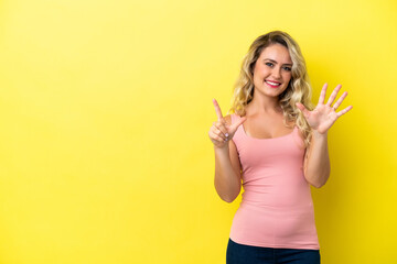 Young Brazilian woman isolated on yellow background counting seven with fingers