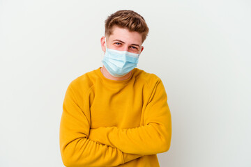 Young man wearing a mask for coronavirus isolated on white background laughing and having fun.