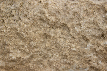 texture of yellow rough stone. Abstract background from yellow stone wall