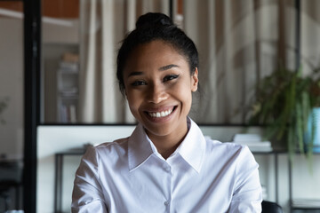 Headshot portrait of smiling African American young woman worker employee have webcam digital...