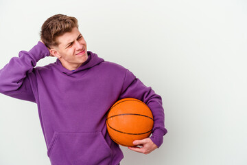 Young caucasian man playing basketball isolated background touching back of head, thinking and making a choice.