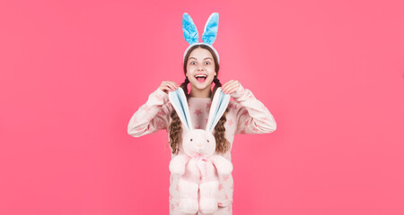 happy easter child girl in bunny rabbit ears and pajamas play with toy, easter