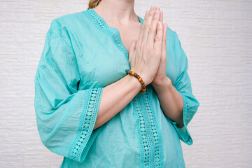 Woman ethnic clothes hold hands together is symbol prayer and gratitude, wai or namaste gesture, sign of thankfulness and and greeting