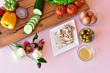 Healthy mediterranean ingredients with vegetables and chicken to make fresh nutritious salads and meals. Photo concept, background, table top view, copy space, healthy lifestyle