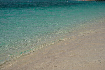 Small waves lap on the shore of the Cayman Islands in the British West Indies
