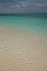 Small waves lap on the shore of the Cayman Islands in the British West Indies