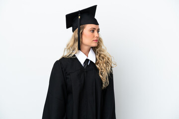 Young university graduate woman isolated on white background looking to the side