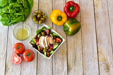 Healthy mediterranean ingredients with vegetables and chicken to make fresh nutritious salads and meals. Photo concept, background, table top view, copy space, healthy lifestyle