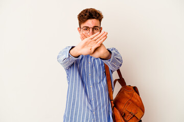 Young student man isolated on white background doing a denial gesture