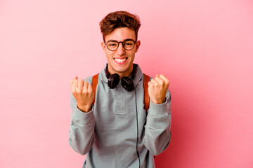 Young student man isolated on pink background cheering carefree and excited. Victory concept.