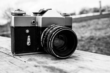 forgotten old film camera lies in the garden