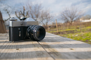 forgotten old film camera lies in the garden