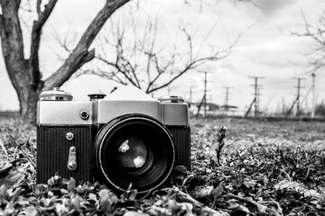 forgotten old film camera lies in the garden