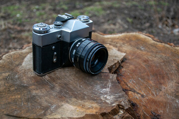 forgotten old film camera lies in the garden