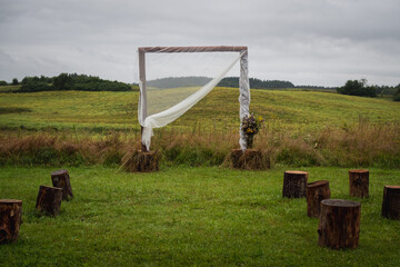 Marital arch in a wild meadow. Boho style