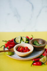 plate of chiles, cilantro, and lime on for thai soup