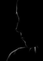 Black and white face contour of a young woman. Black space