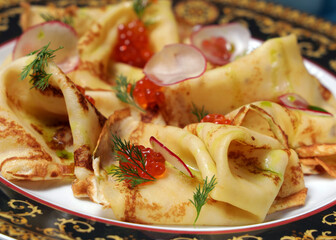 thin pancakes with red caviar