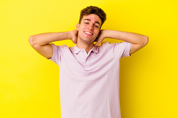 Young caucasian man isolated on yellow background stretching arms, relaxed position.