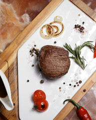 Large steak with sauce on the board