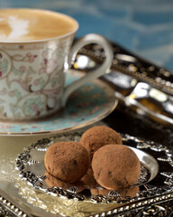 cappuccino with chocolate candy on a tray
