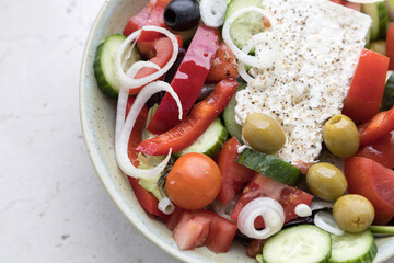 Cooked greek salad with paprika,tomatoes,cucmber and cheese feta .
Flat lay