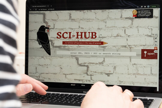 Sci-Hub library seen on the screen of laptop and a student in front of it. Sci Hub gives a free access to research papers books. Stafford, United Kingdom, March 21, 2021.