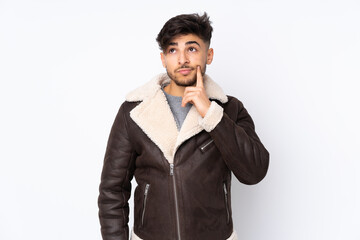 Arabian handsome man over isolated background having doubts and thinking