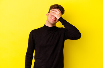 Young caucasian man isolated on yellow background covers eyes with hands, smiles broadly waiting for a surprise.