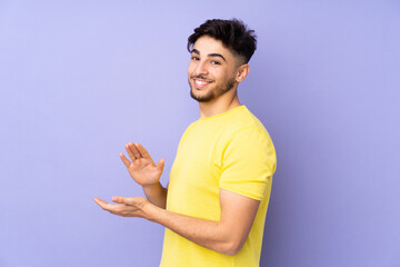 Arabian handsome man over isolated background applauding
