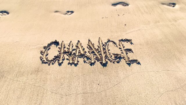 Change handschriftlich in den Sand geschrieben vor Fussabdr&uuml;cken und vorbeilaufendem Jogger