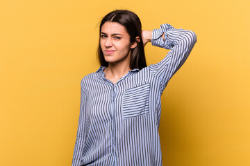 Young Indian woman isolated on yellow background suffering neck pain due to sedentary lifestyle.