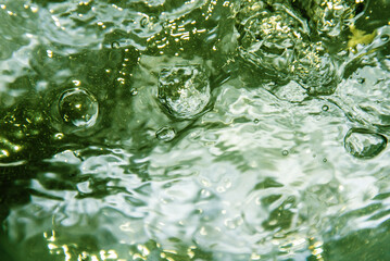 Naklejka na ściany i meble Surface of intensive boiling water with bubbles and swirls
