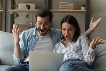 Close up overjoyed young couple looking at laptop screen, reading unexpected good news, celebrating success, online lottery win, money refund, excited wife and husband received good news in email