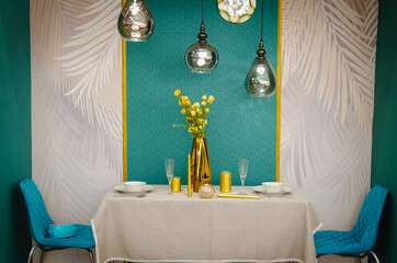 Two chairs and a table with candles.
