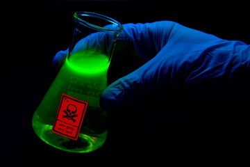 Toxic sample hold by a scientist in a laboratory - radioactive - fluorescence