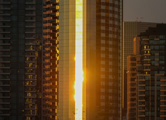 Orange sunset reflecting off a city building