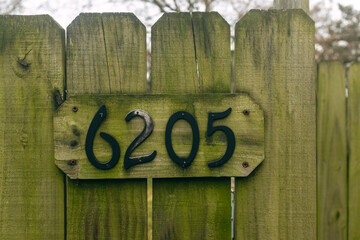 Black numbers on a wooden fence