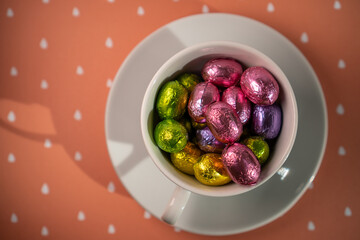 cup with chocolates orange background