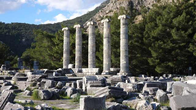 Ruins of Temple of Athena in ancient Greek city of Priene overlooking five reconstructed columns on sunny winter day, Turkey