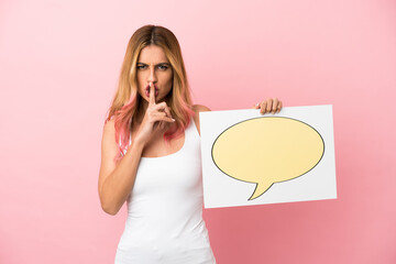 Young woman over isolated pink background holding a placard with speech bubble icon doing silence gesture