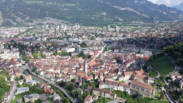 View from drone of houses of swiss Chur city in mountain valley in sunny summer day
