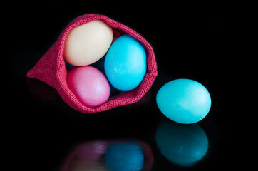 Easter eggs in a bag, on a black background. Easter Concept