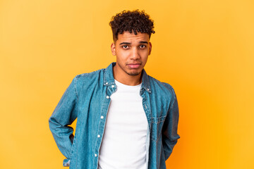 Young african american curly man isolated on purple sad, serious face, feeling miserable and displeased.