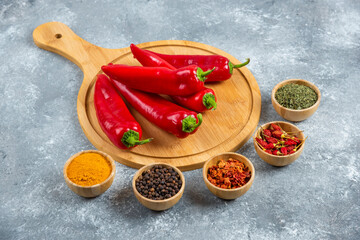 Red chili peppers on wooden board with spices