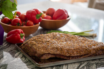 Raw Spiced Rubbed Beef Brisket on marble kitchen counter